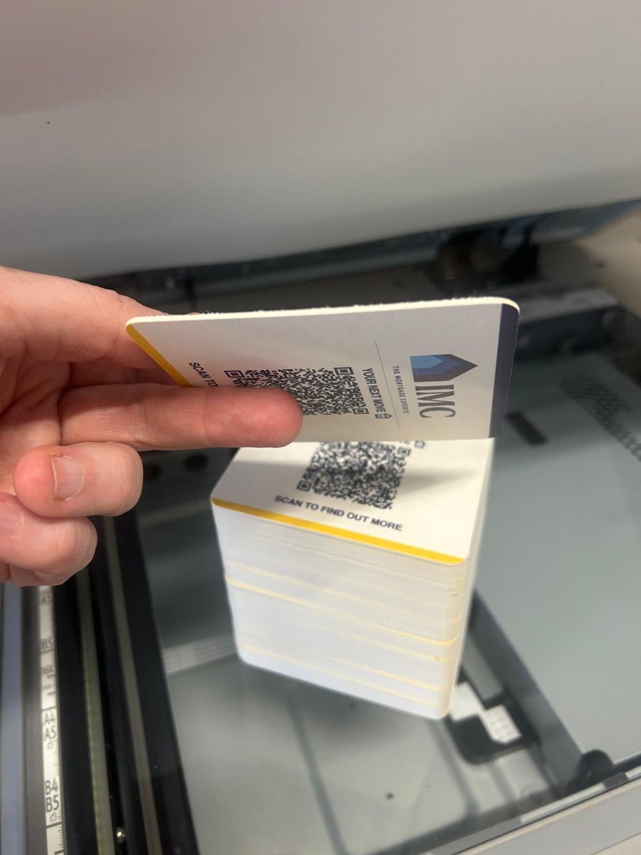 Printed beermat held in hand showing the yellow edge colour