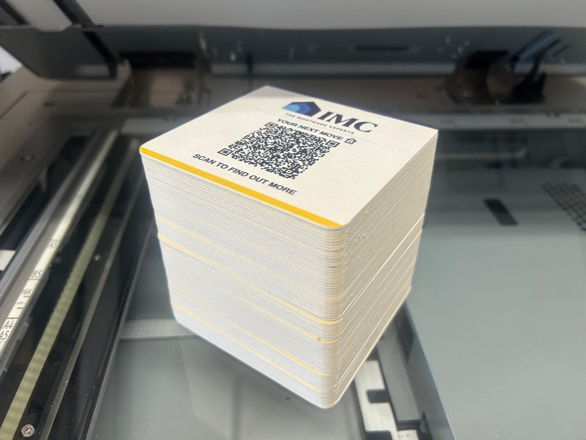 Tall stack of printed beermats with the QR code side up