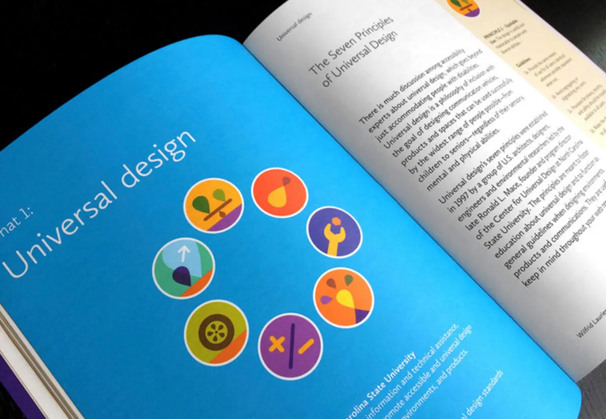 Open book on universal design with accessibility icons