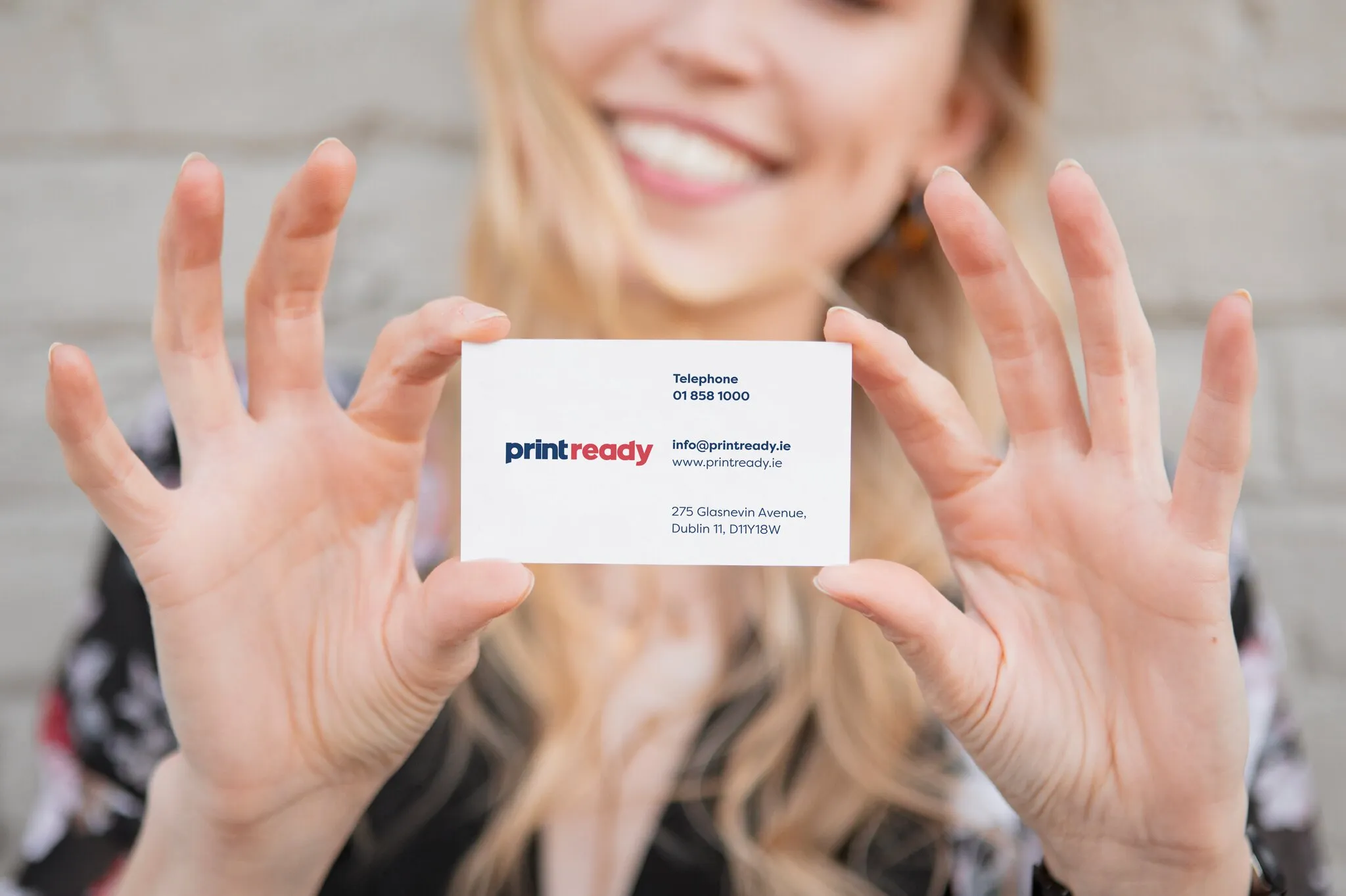 Print Ready business card held by a customer