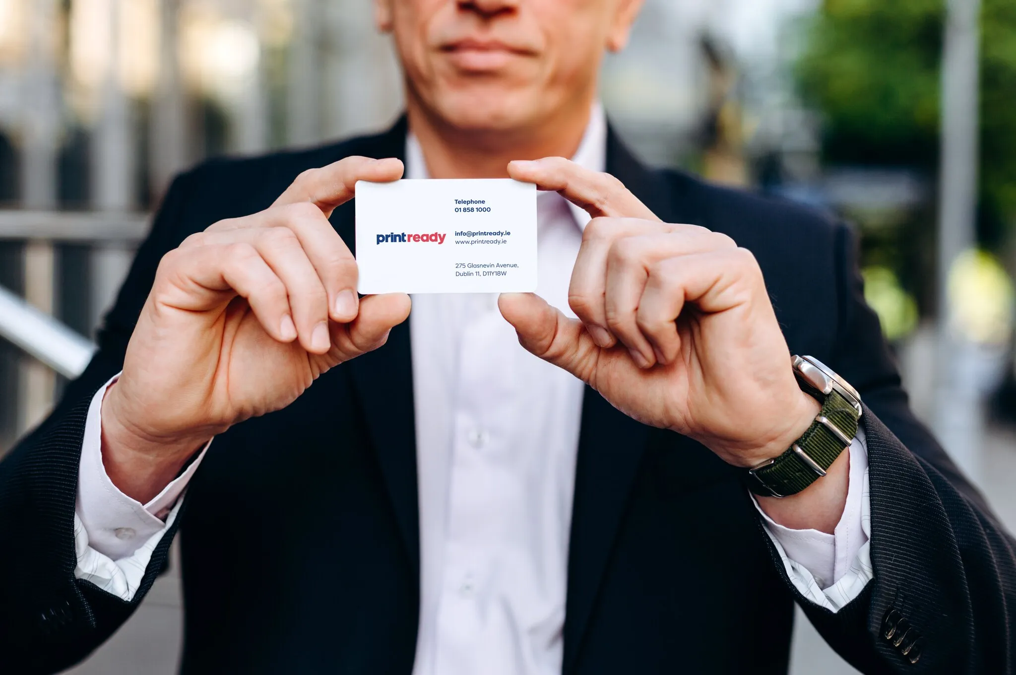 Print Ready business card held by a businessman
