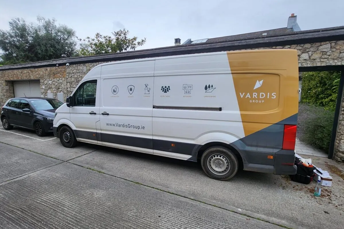 Vardis Group branded van outside stone building