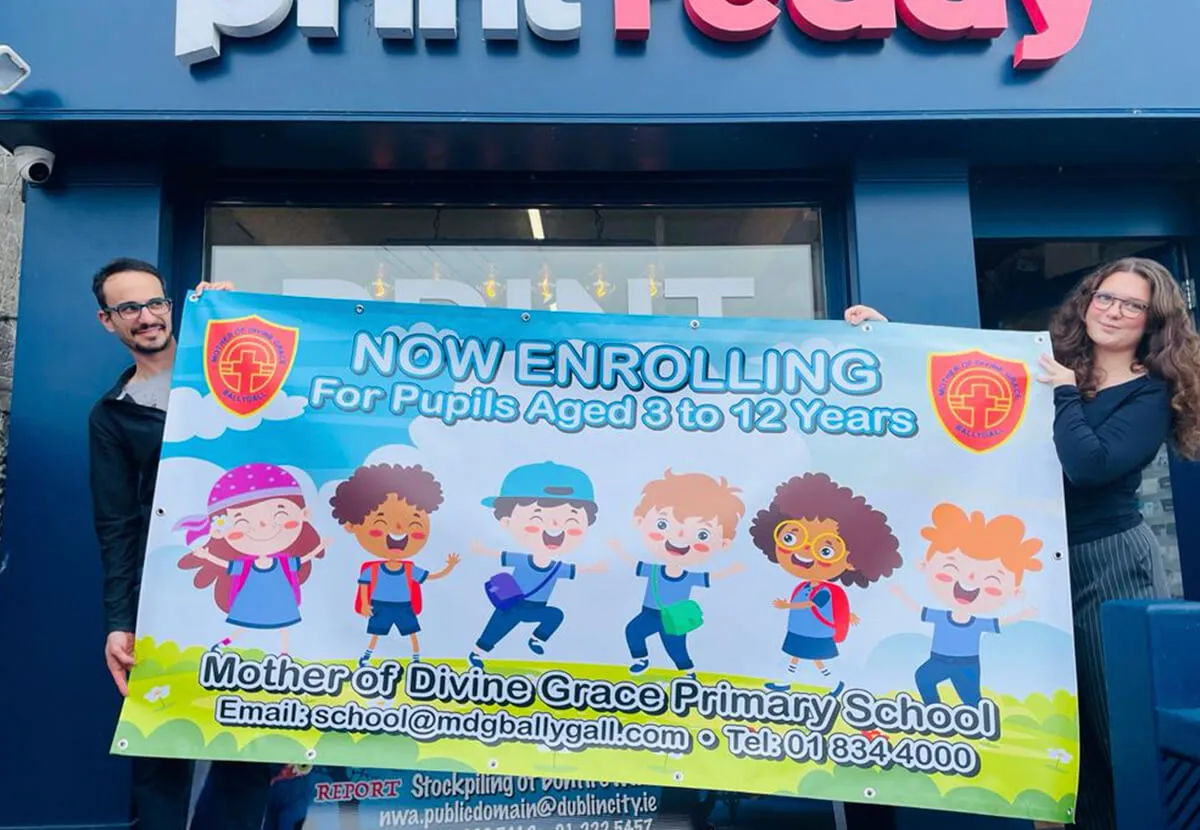 School enrolment PVC banner printed by Print Ready held outside a shop