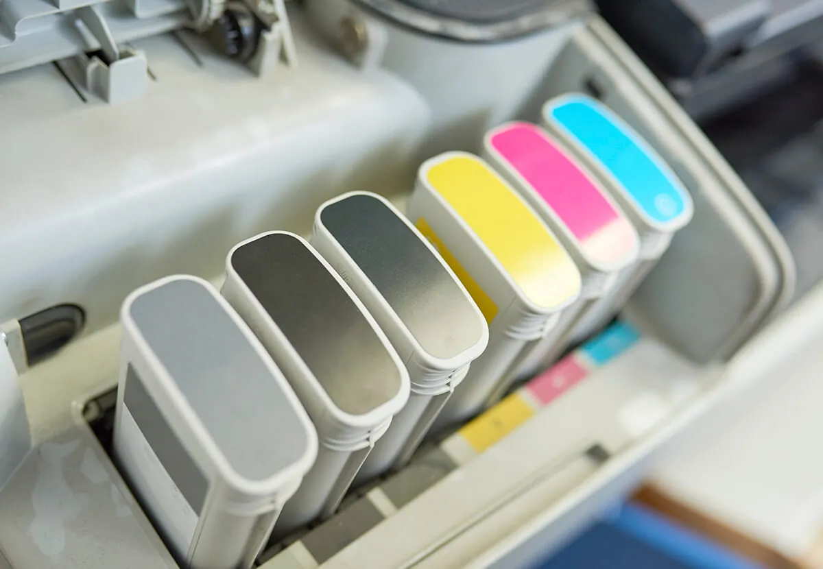 CMYK ink cartridges in an offset press
