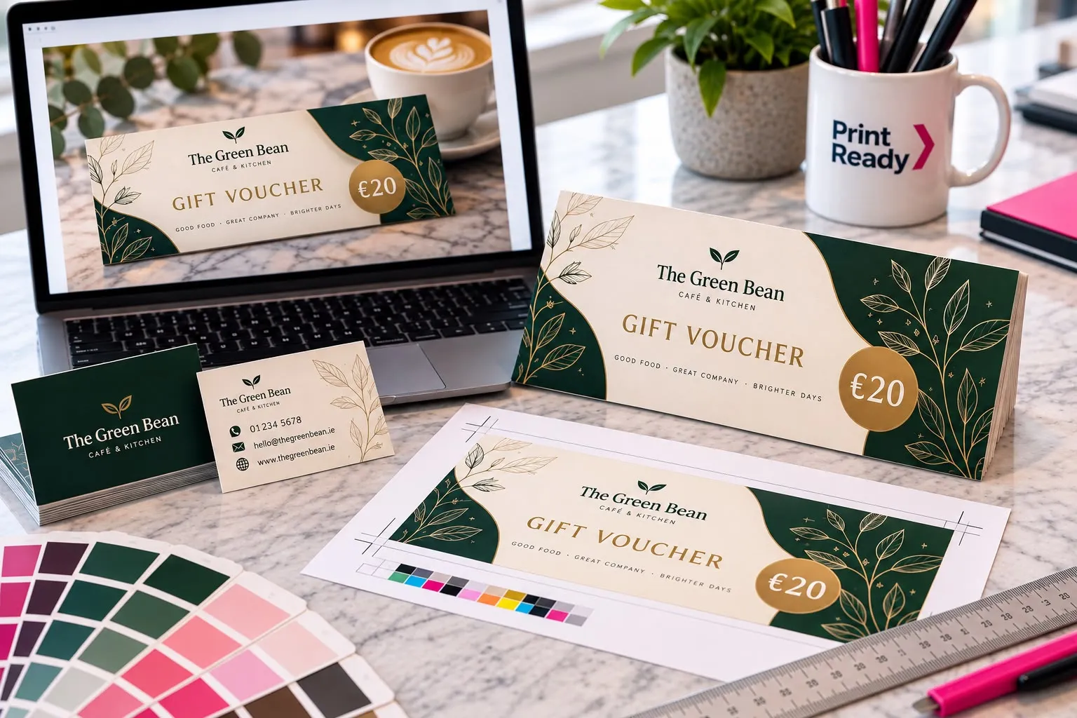A gift voucher design for a fictional café shown on a laptop and printed, with business cards and colour swatches