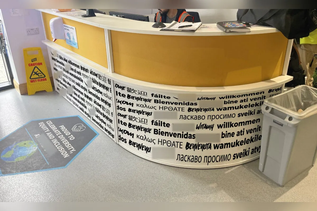 Fulfilment centre reception desk wrapped in multilingual welcome graphics