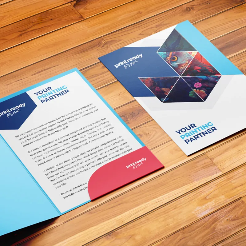 Print Ready presentation folder open on a wooden table with printed inserts