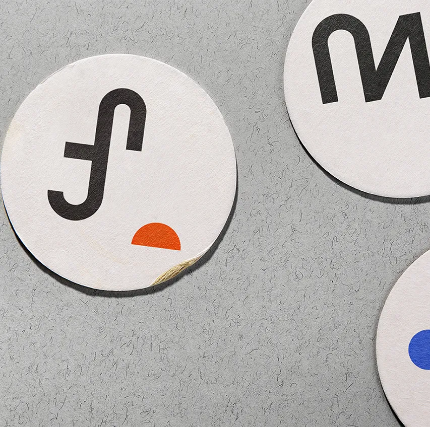 Round branded beermats on bar counter