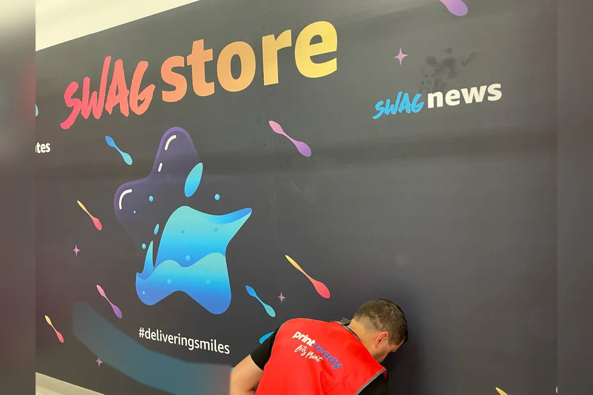Fulfilment centre swag store wall graphic being installed