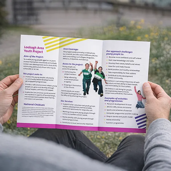 Holding a physical printed leaflet proof outdoors to check colours in real light