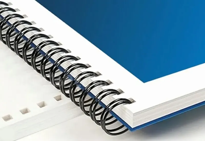 Close-up of wire-O binding on a document with blue cover