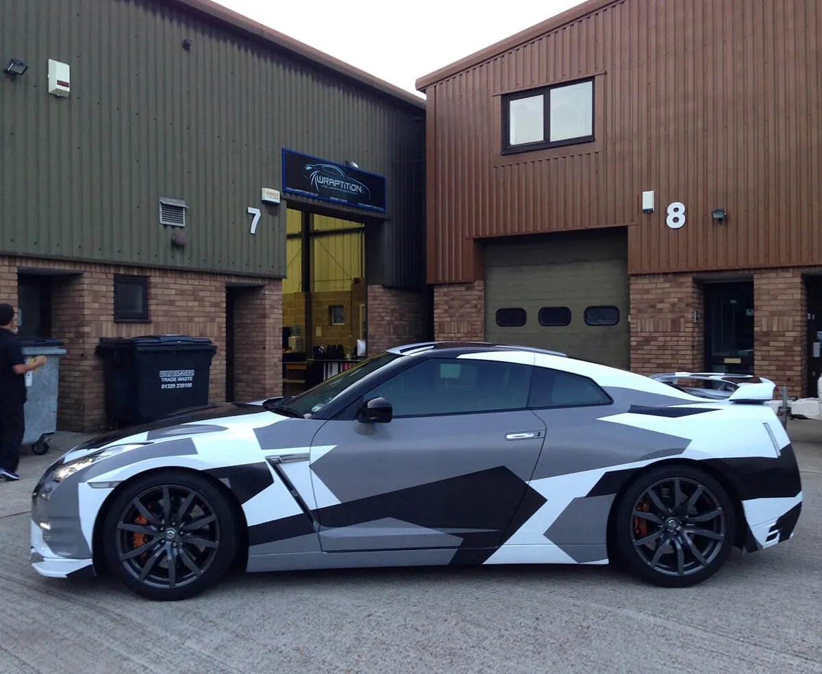 Camouflage-wrapped Nissan GT-R with a custom car skin