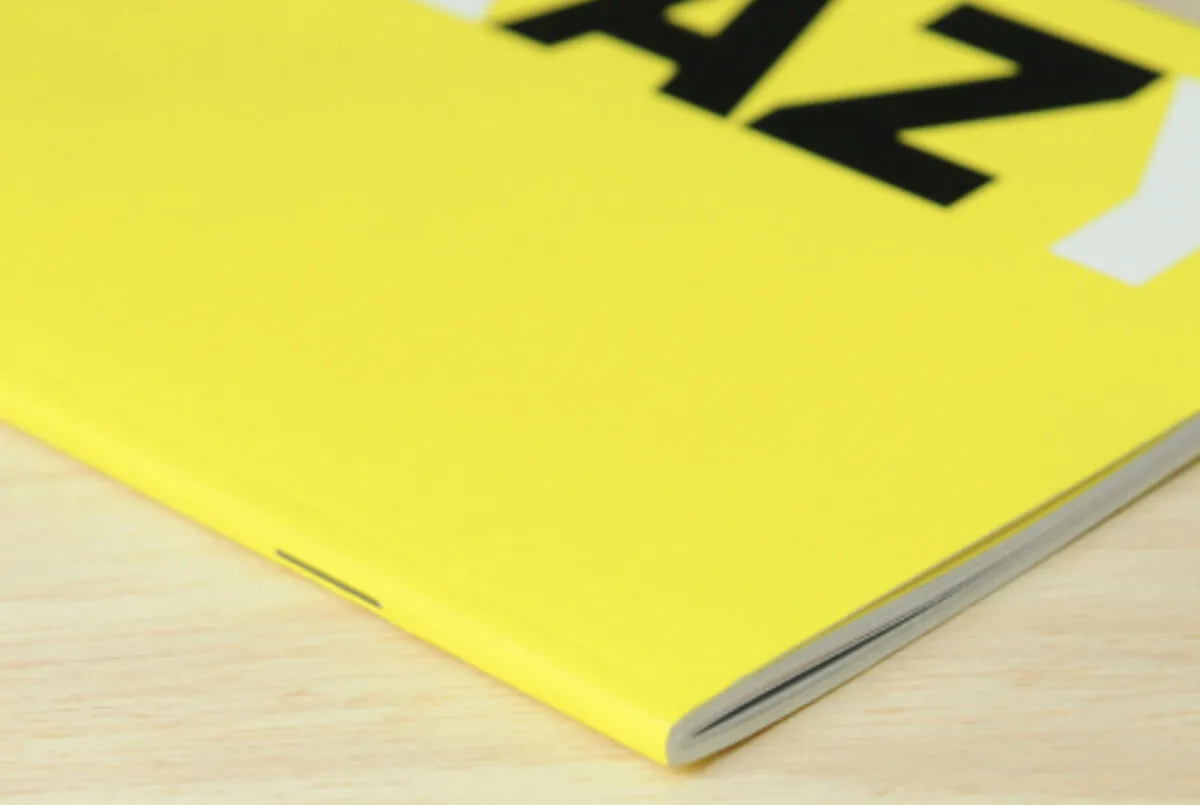 Bright yellow printed brochure with bold typography
