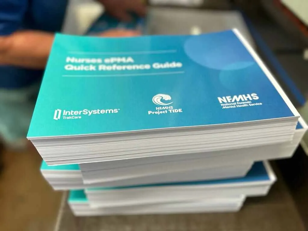 Stack of printed quick reference guide booklets