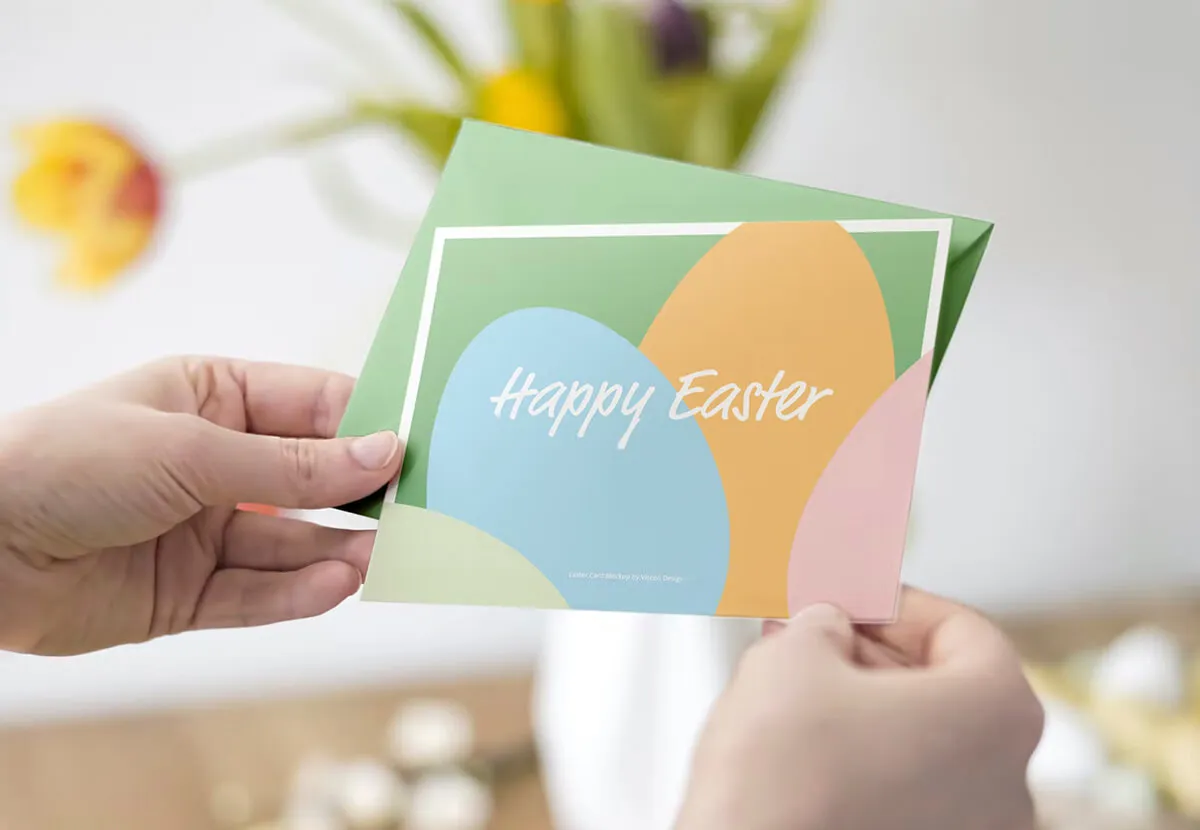 Hands holding a printed Happy Easter card