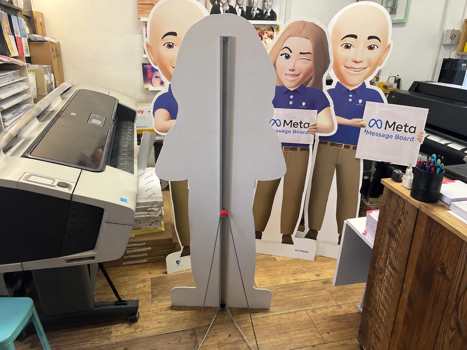 Life-size Meta avatar cut-out holding an A4 acrylic message holder, printed by Print Ready