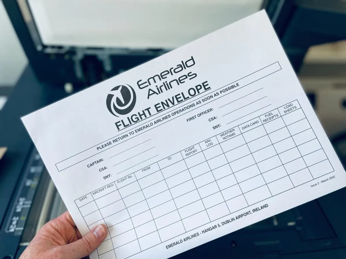 Emerald Airlines flight envelope held in hand - Print Ready