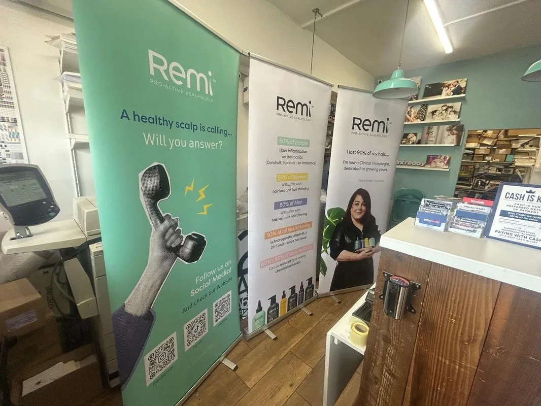 Remi pull up banners, wide shot of all three in the Print Ready shop