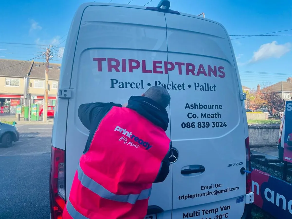 Tripleptrans van rear door decals being fitted