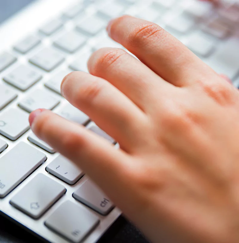 Hands typing on computer keyboard for typesetting work