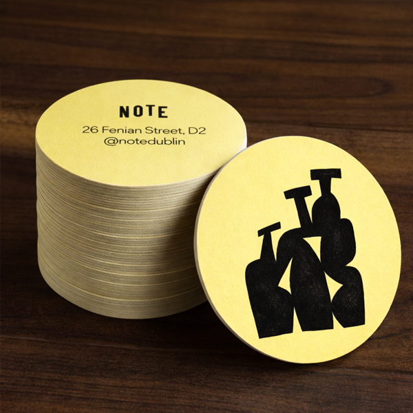 Stack of custom printed yellow beermats for NOTE bar on Fenian Street, Dublin
